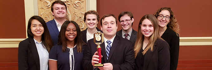 Group of students posing with an award.